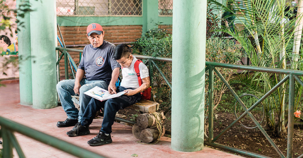 student studying with his father