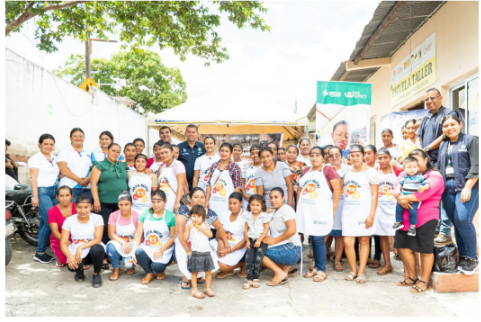 Group of school cooks with Seeds for Progress staff outside a school