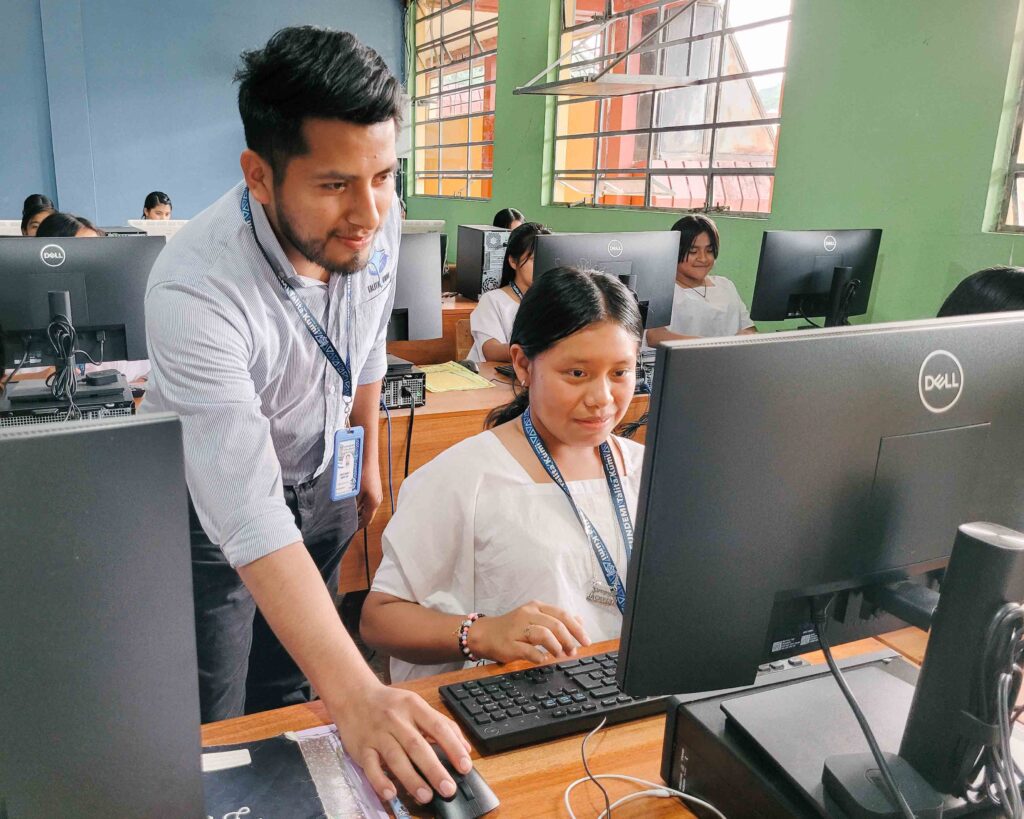 Talita Kumi Educator, Angel with student in computer lab teaching