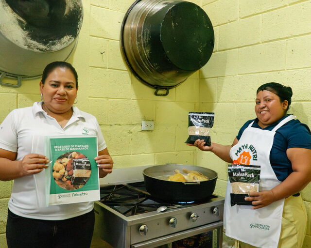 Cook and Mannapack A cook and educator pose in front of the kitchen stove with MannaPack
